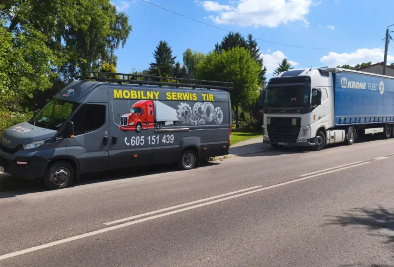 Mobile truck service van parked by the road behind a Volvo tractor unit with a Krone trailer