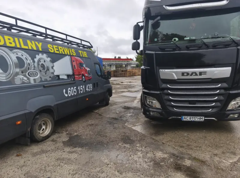 Mobile truck service van next to a black DAF XF tractor unit on a yard