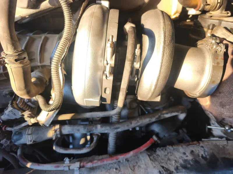 Close-up of the turbocharger and pipework in a truck engine bay