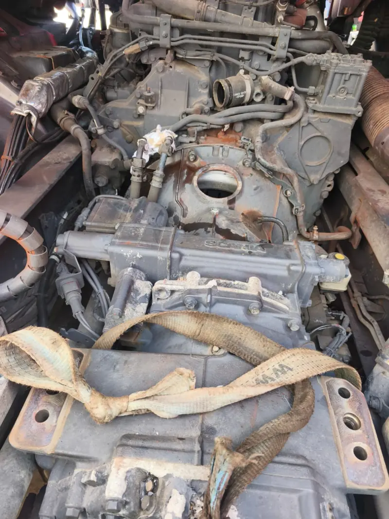 Scania gearbox supported on a lifting strap underneath the truck
